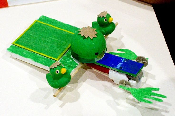 A cardboard-and-tape turtle with two duckling heads and a scanner-tray body