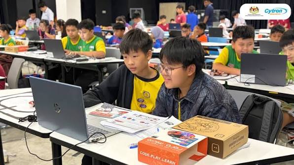 Participants building and coding at a robotics workshop
